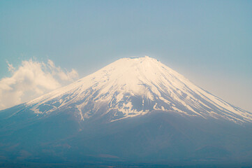 Fototapeta premium Close up top of beautiful Fuji mountain with snow cover on the top with could in Japan,Banner cover background.