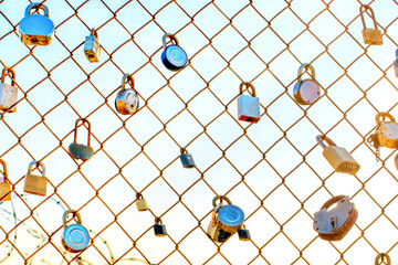 Padlocks on a Chain Link Fence at Sunset