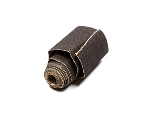 Dark sandpaper rolled up, on a white background.