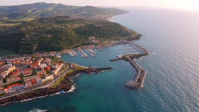 4k drone forward video (Ultra High Definition) of Castelsardo port. Splendid sunrise on Sardinia island, Province of Sassari, Italy, Europe. Fantastic spring seascape of Mediterranean sea.