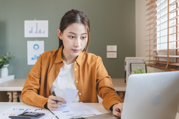 person using calculator calculating tax refund on the table