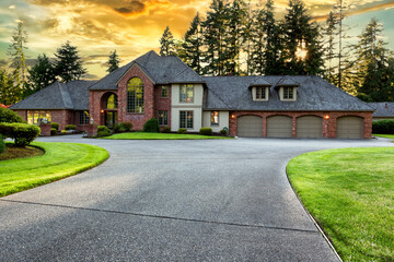 Beautiful luxury home exterior in early evening during golden sunset - 593604029