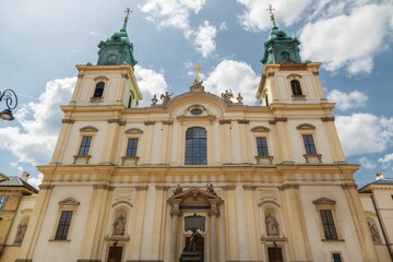 Fototapeta na wymiar Low angle of the Holy Cross Church in baroque architectural style in Warsaw, Poland