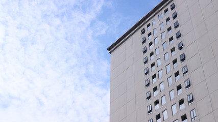 A towering building with a glass window exterior outside.