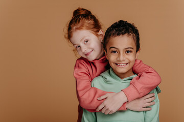 Boy with his friend posing during studio shoot.