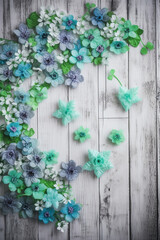 Fototapeta na wymiar Blue Blossoms on Light Wooden Background