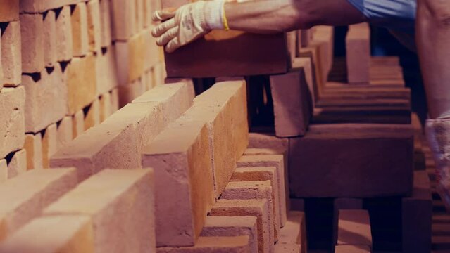 Workers placing odschool bricks in rows before firing. Closeup shot. Slow motion 50perc. 4k.