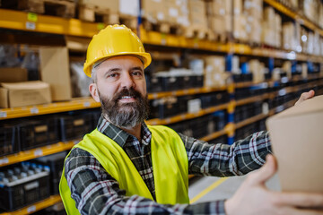Warehouse worker stocking goods in a warehouse.