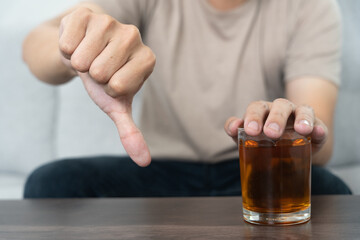 man refuses say no and avoid to drink an alcohol whiskey , stopping hand sign male, alcoholism treatment, alcohol addiction, quit booze, Stop Drinking Alcohol. Refuse Glass liquor, unhealthy, reject