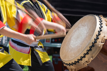 A Taiko drummer performs on stage 