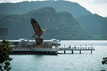 Big Eagle statue perched over a scenic waterfront plaza in Langkawi, Malaysia.