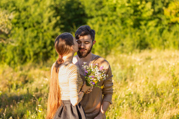 man giving wild flowers to his girlfriend