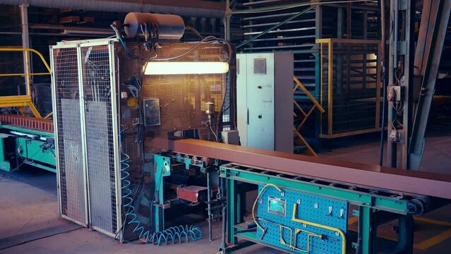 Production line of red bricks. Machine cuts fresh clay material into bricks before putting those on shelves for drying. 4k.