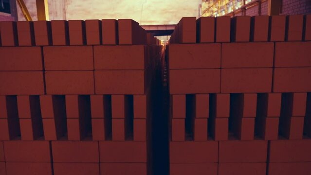 Full warehouse of bricks. Stocked before firing process. Layed in special manner. Vintage. Camera tilt for great epic effect. Slow motion 50perc. 4k.