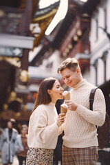 newlywed couple eating ice cream from a cone on a street in Shanghai near Yuyuan China.
