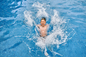 Child jump, swim in the pool, sunbathes, swimming in hot summer day. Relax, Travel, Holidays
