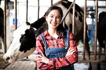 Young Asian confident female farmer or worker of farmhouse crossing arms on chest while standing in...