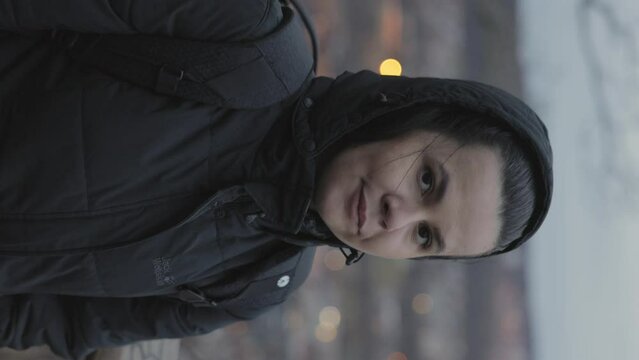 Vertical - European Woman In Hooded Winter Jacket Admiring Cityscape Of Jonkoping In Sweden. panning rack focus reveal