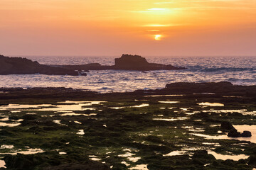 Picturesque sunset on the Atlantic Ocean in the area of Essaouira in Morocco on a summer evening.