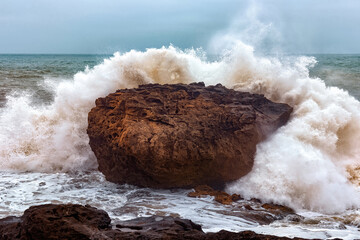 View of the gigantic rocky stone in the stormy Atlantic Ocean in the area of Essaouira in Morocco.