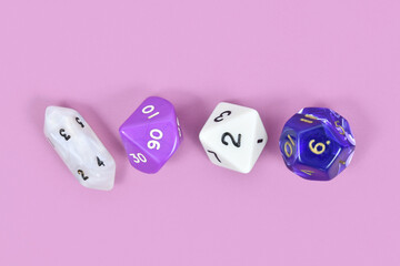 Different roleplaying RPG dice on violet background