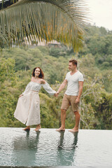 Couple standing on a forest backgroung on a Bali