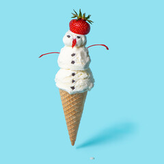 summer funny creative concept of cone with scoops ice cream snowman isolated on blue background, cool ice cream concept in hot summer