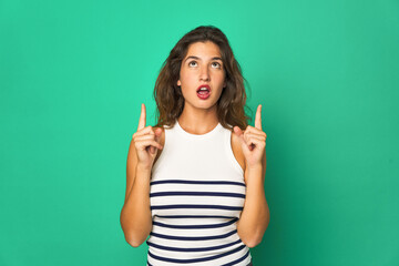 Young caucasian woman isolated pointing upside with opened mouth.