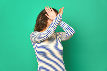 Young caucasian woman isolated keeping two arms crossed, denial concept.