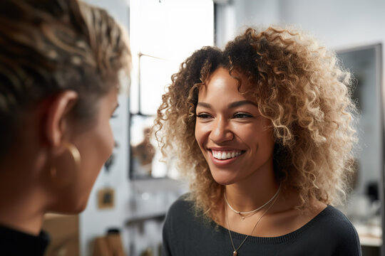 Generative AI illustration of cheerful young ethnic female with curly hairstyle smiling and looking at crop friend while talking about life during meeting