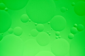 Abstract background with green oil circles on the water.