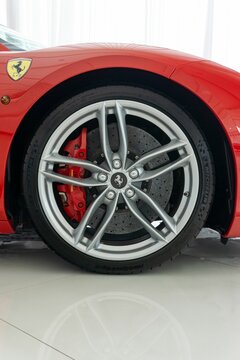 Vertical shot of a Ferrari 488 GTB Rosso Corsa with a silver wheel with carbon hub cap