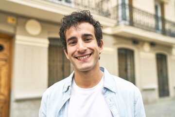 Fototapeta premium Young handsome caucasian man at outdoor happy, smiling and cheerful.