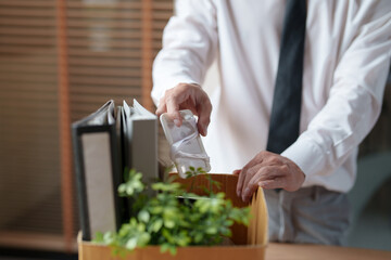 Resignation concept.Businessmen packing Stuff with cardboard box for quit a job..