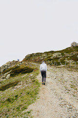 Tourist going up to the refuge in Turo de l'Home. House at the top of the mountain. Montseny Natural Park. Barcelona. Catalonia. Spain. Europe