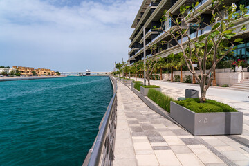 Promenade alongside the Dubai Canal with apartments near to coast at Jumeirah