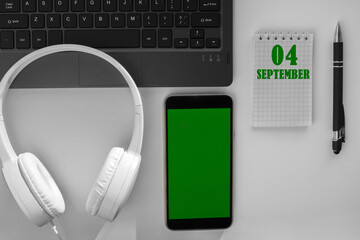 calendar date on a light background of a desktop and a phone with a green screen. September 4 is...