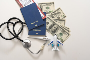 stethoscope, toy airplane on a white background. health insurance on a travel trip