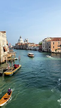 Grand Canal in Venice, Italy. Floating boats and historic buildings. Visiting European cities.