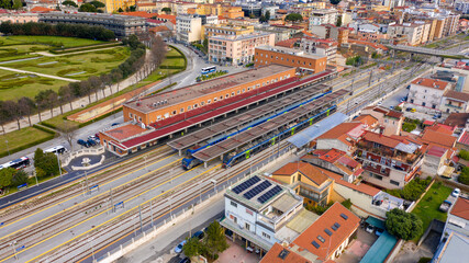 Aerial view of the Caserta train station, in Campania, Italy. There are some trains stopped on the tracks. - obrazy, fototapety, plakaty