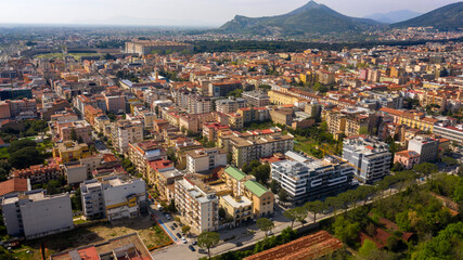 Fototapeta na wymiar Aerial view of the historic center of Caserta, in Campania, Italy. In background the Royal Palace of Caserta also known as Reggia di Caserta, symbol of the city.