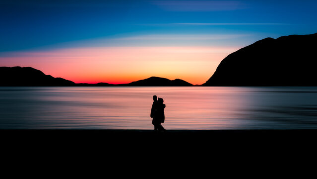 silhouette of a couple walking at sunset