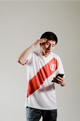 Photograph of Peruvian fan celebrating a goal of his team. Concept of people, emotions and sports.