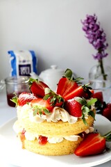 Victoria sponge cake with strawberries and fresh cream
