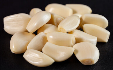 Garlic cloves. Raw garlic isolated on black background. Vegetable