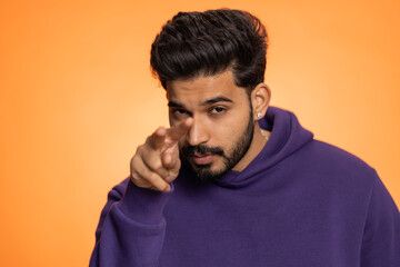 I am watching you. Young confident indian man pointing at his eyes and camera, show I am watching...