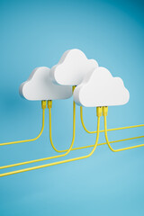 Cloud Computing Concept - Three clouds with plugged in Ethernet Cables. Blue background.