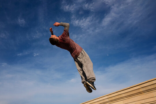 Man doing parkour. Free runner - Powered by Adobe