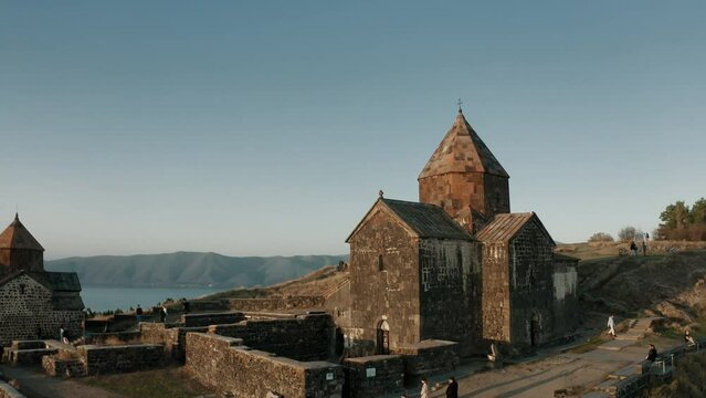 Aerial drone view of Sevanavank monastic complex and Sevan lake during golden hour