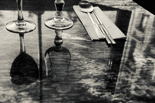 Reflection of typical Parisian building in marble table of traditional asian restaurant. Paris, France. Beauty and art in everyday life. Black white historic photo.